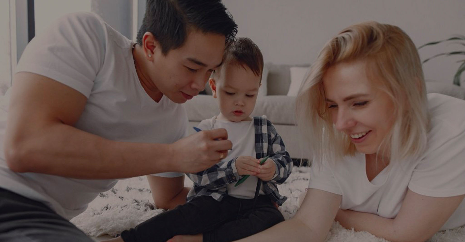 A family enjoying crafts with their young child.