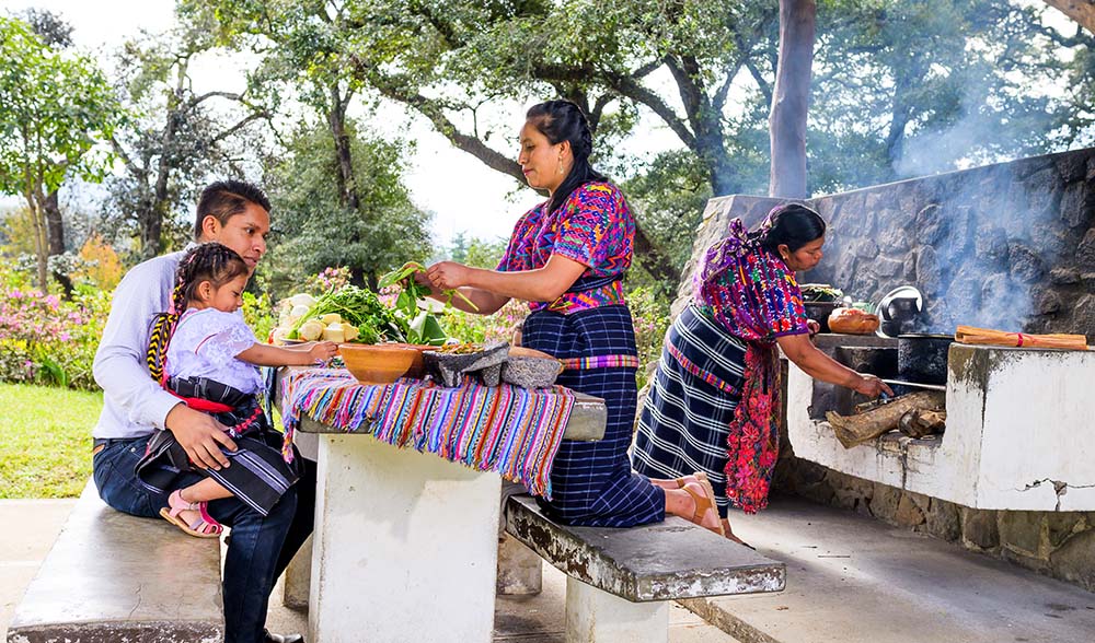 A father and his young daughter learn how a traditional Mayan meal is made.