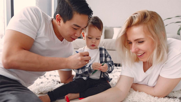 A family enjoying crafts with their young child